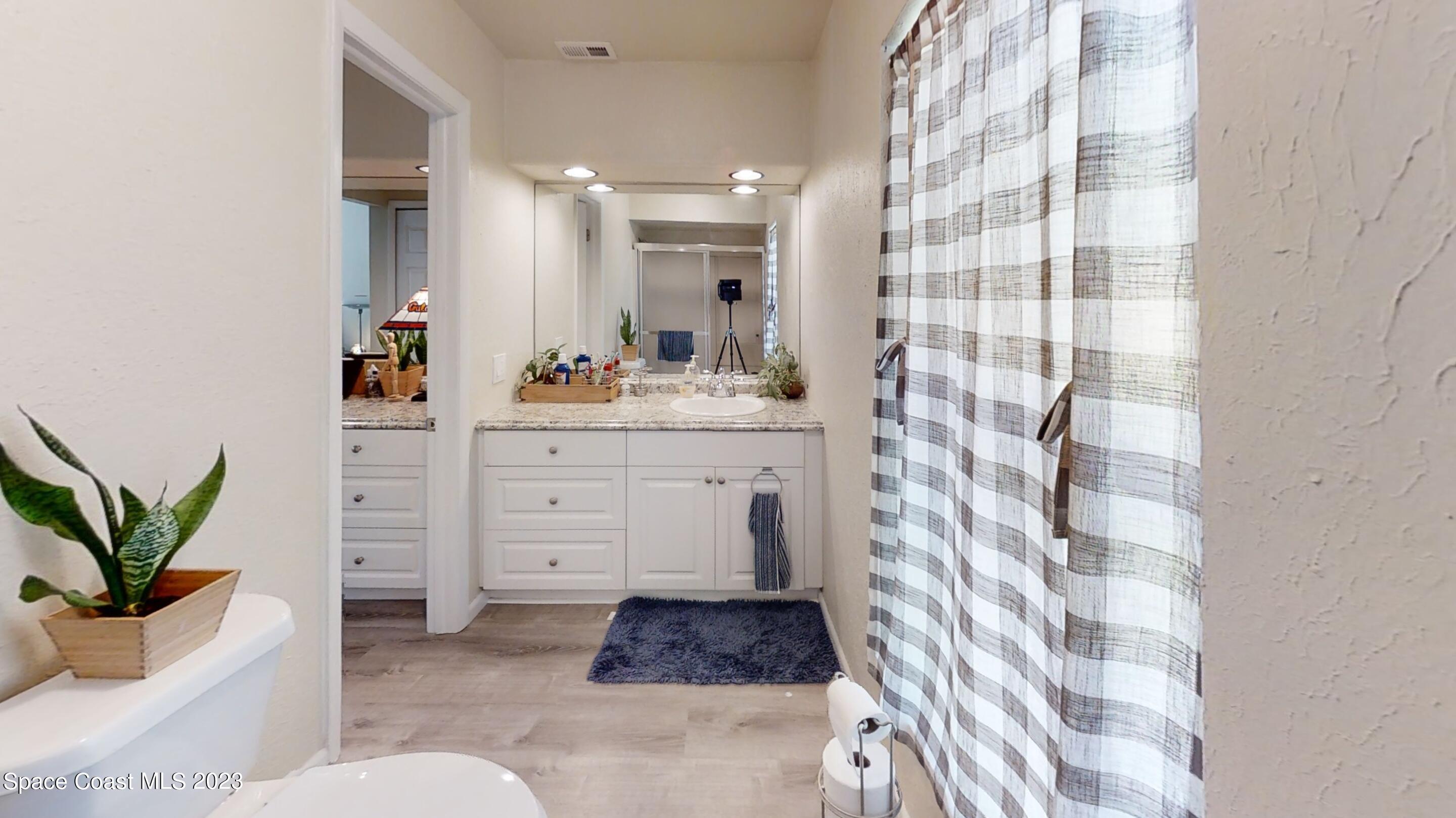 295 Bayhead Drive Melbourne, FL 32940 - Photo 14 of 19 a spacious bathroom with a double vanity sink a mirror and a shower