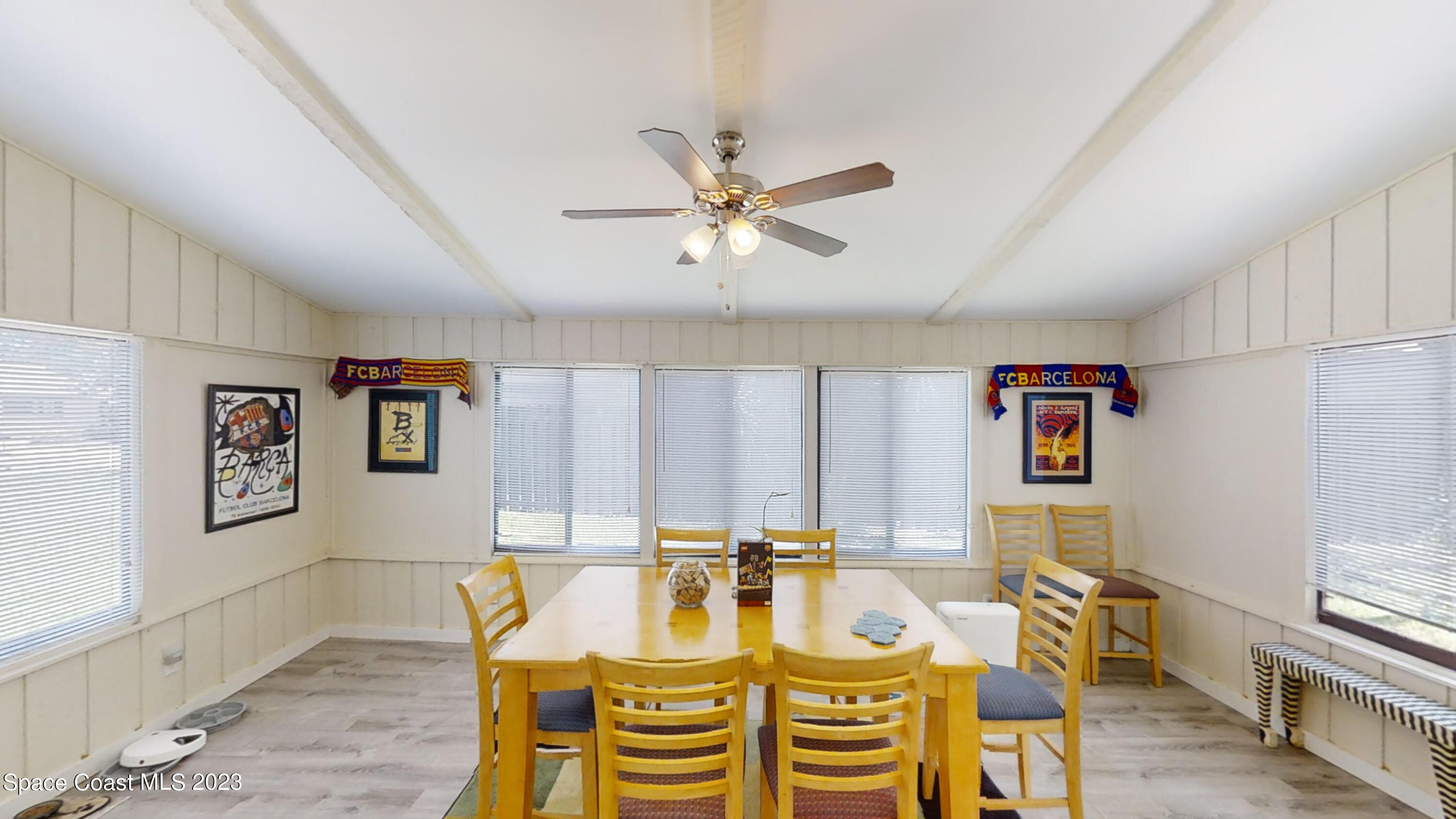 295 Bayhead Drive Melbourne, FL 32940 - Photo 7 of 19 a view of a dining room with furniture a chandelier and wooden floor