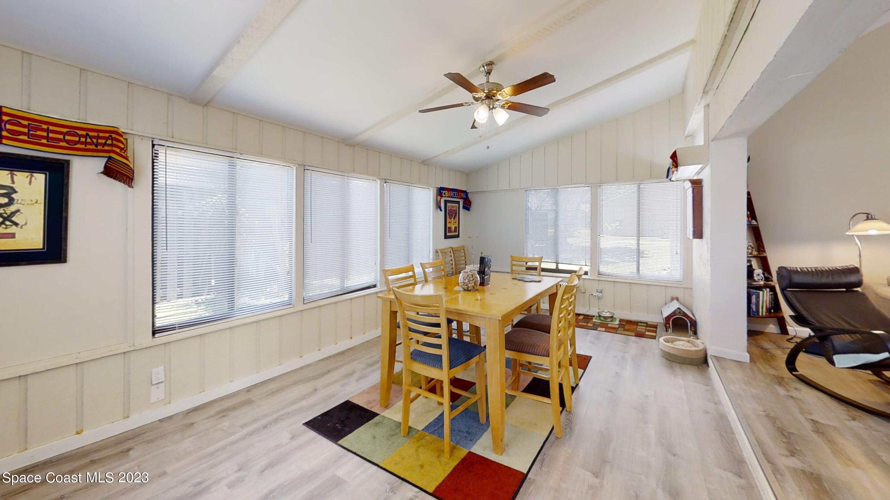 295 Bayhead Drive Melbourne, FL 32940 - Photo 8 of 19 a dining room with wooden floor and a window