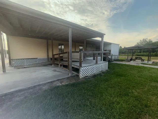 a backyard of a house with table and chairs