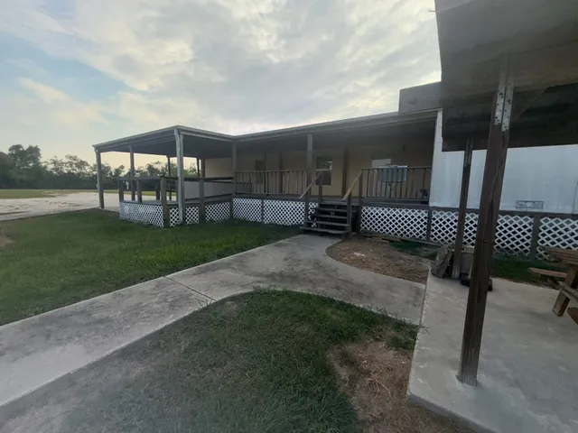 a backyard of a house with table and chairs