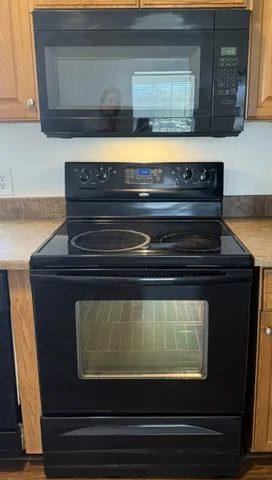 a stove top oven sitting inside of a kitchen