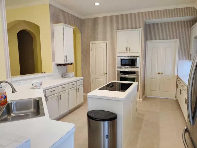 a utility room with sink dryer and washer