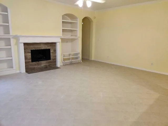 a view of empty room with a fireplace