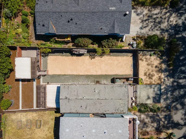an aerial view of a house with a yard and a large tree