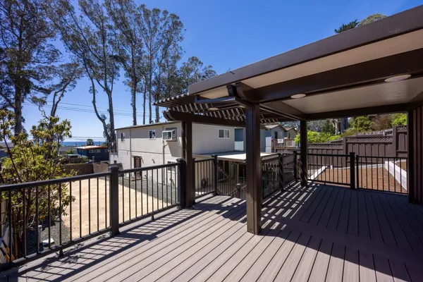 a view of a house with wooden deck