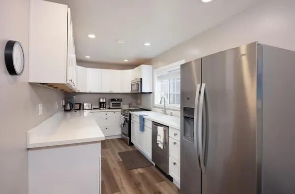 a kitchen with a white cabinets stove and refrigerator