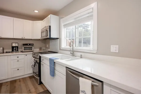 a kitchen with a sink stove and cabinets