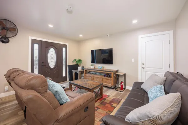 a living room with furniture and a flat screen tv