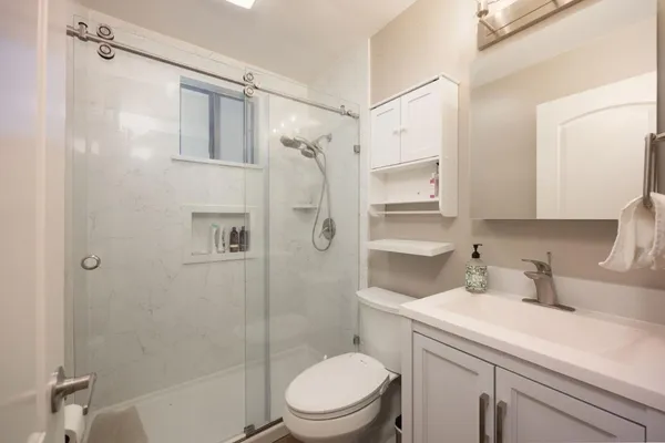 a bathroom with a sink toilet and shower