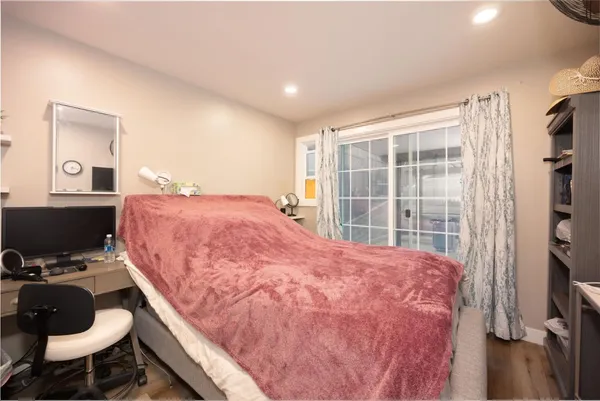 a bedroom with a bed and a desk