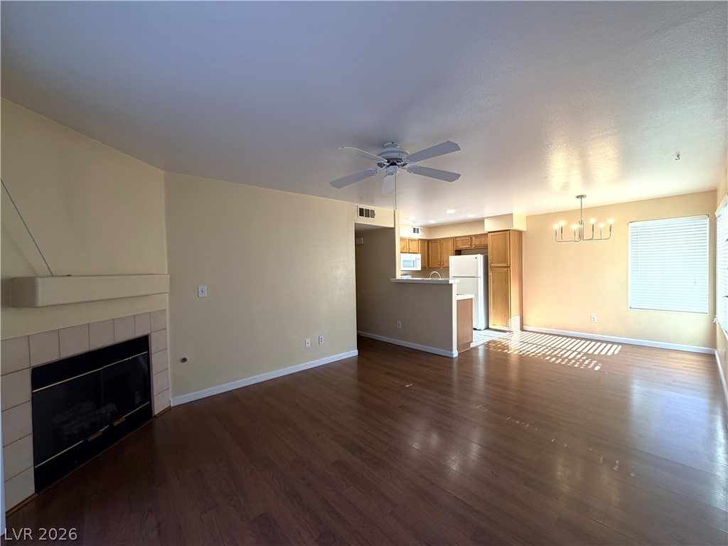 4955 South Lindell Road, Unit 203 Las Vegas, NV 89118 - Photo 9 of 31 An inviting open-concept living space features warm wood floors and a cozy fireplace.