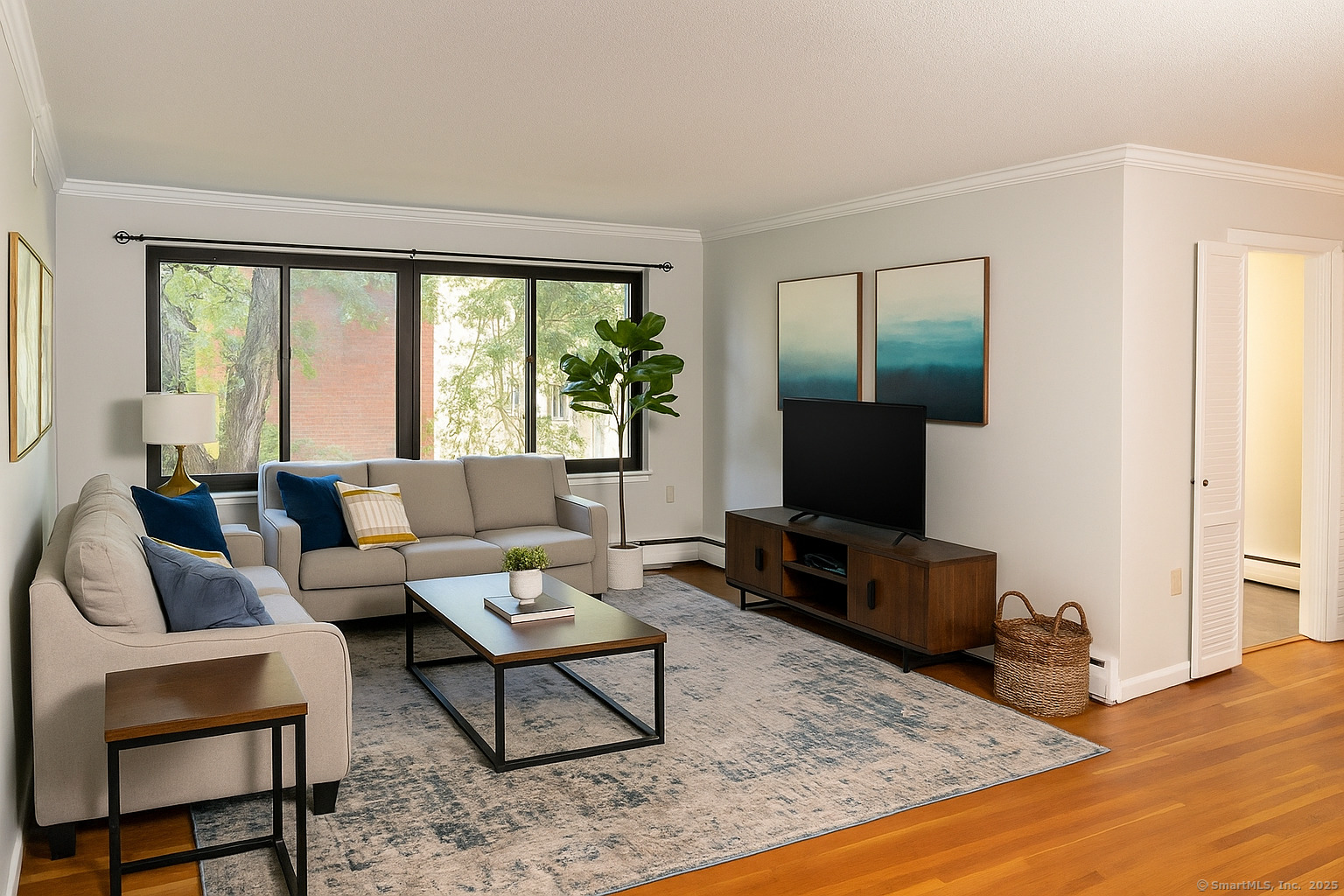 a living room with furniture and a flat screen tv