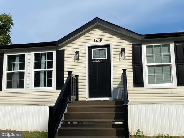 a view of a brick house with large windows