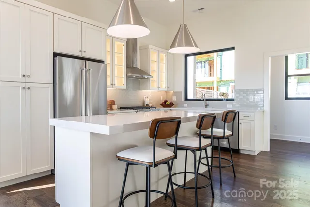 a kitchen with stainless steel appliances a sink a stove and a window