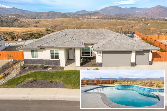 a view of a house with a swimming pool and a yard
