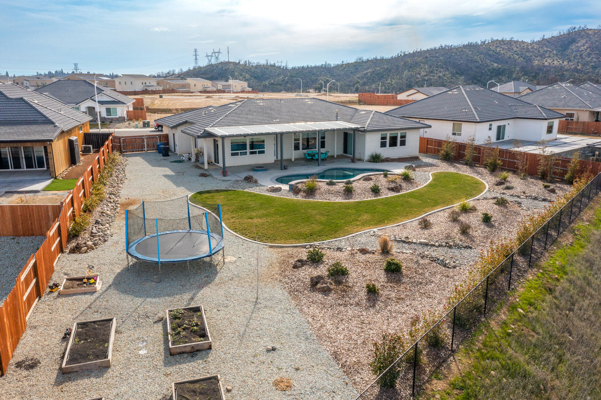 4720 Lower Springs Road Redding, CA 96001 - Photo 21 of 21 an aerial view of a house with swimming pool lawn chairs and fire pit