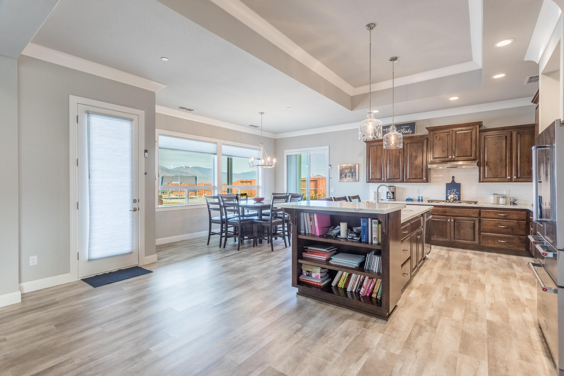 4720 Lower Springs Road Redding, CA 96001 - Photo 5 of 21 a kitchen with stainless steel appliances kitchen island granite countertop a stove top oven a sink a dining table and chairs