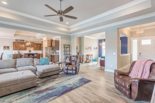 a living room with furniture and a chandelier