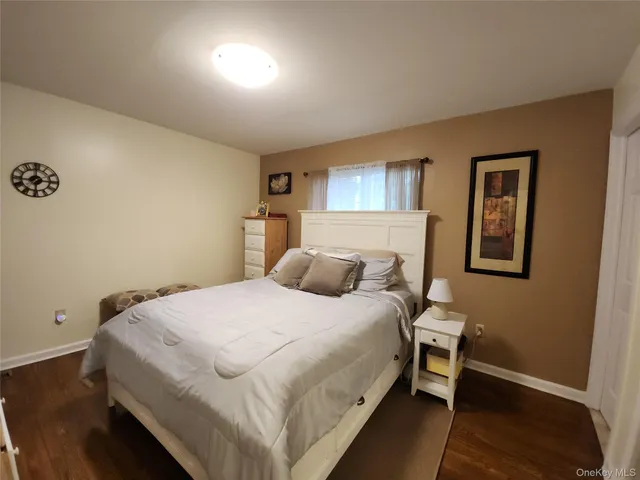 a bedroom with a bed and a night stand