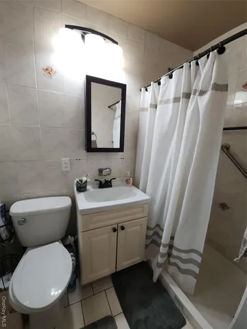 a bathroom with a toilet sink and shower