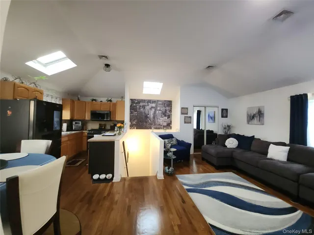 a living room with furniture and kitchen view