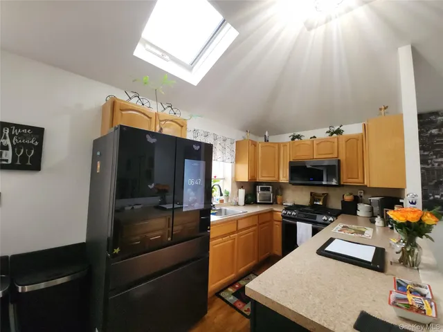a kitchen with stainless steel appliances a stove refrigerator sink and cabinets