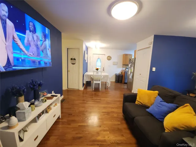 a large white room with furniture and a lamp