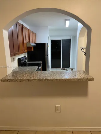 a view of living room kitchen with granite countertop furniture and fireplace