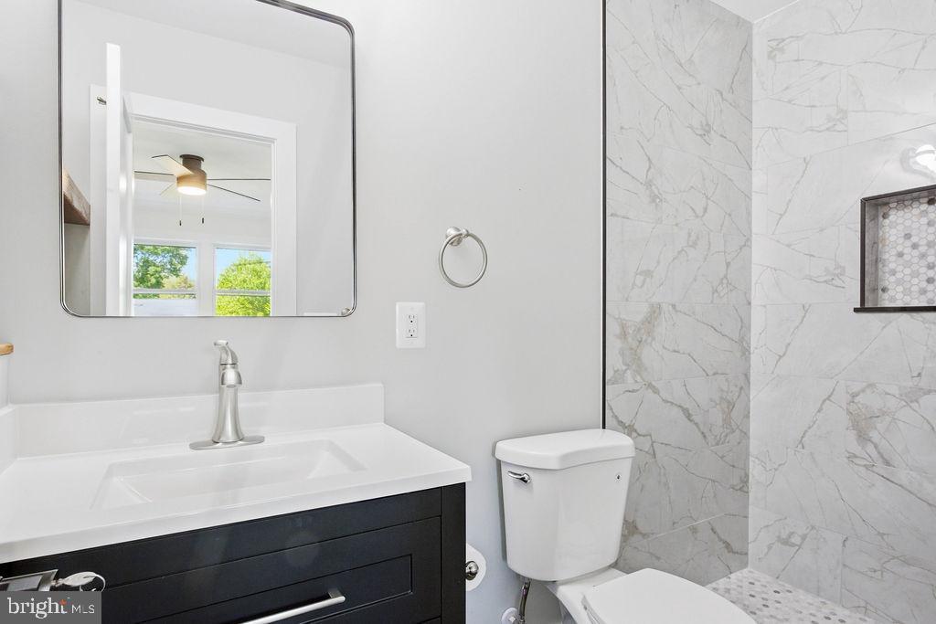 6620 Napoli Road Temple Hills, MD 20748 - Photo 15 of 38 a bathroom with a sink vanity mirror and toilet
