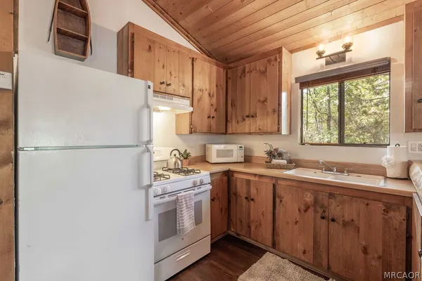 a kitchen with a sink a refrigerator and window