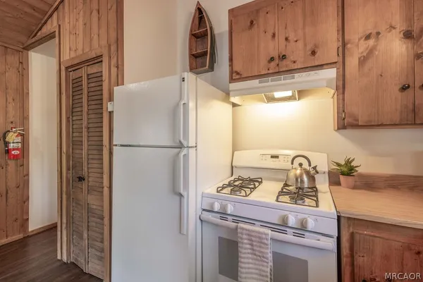 a kitchen with a refrigerator and a stove