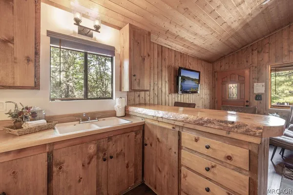 a bathroom with a granite countertop sink mirror and a window