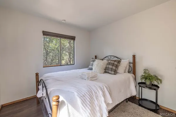 a bedroom with a bed and a potted plant
