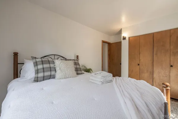 a bedroom with a bed and a mirror
