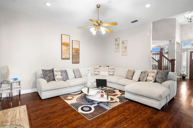 a living room with furniture a rug and a window