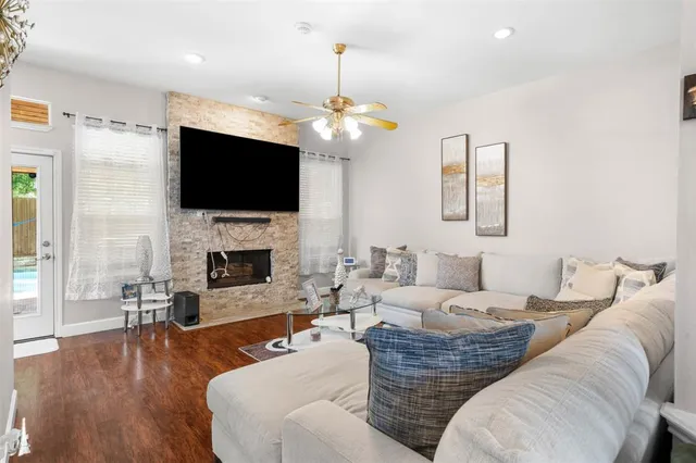 a living room with fireplace furniture and a flat screen tv