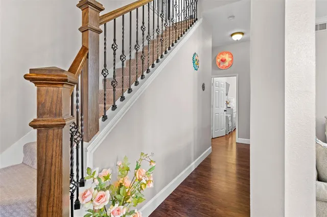 a view of entryway with wooden floor and stairs