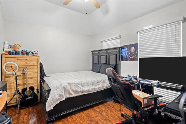 a bedroom with a bed and a desk