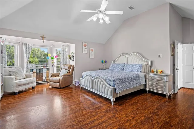 a bedroom with a bed couch and a large window