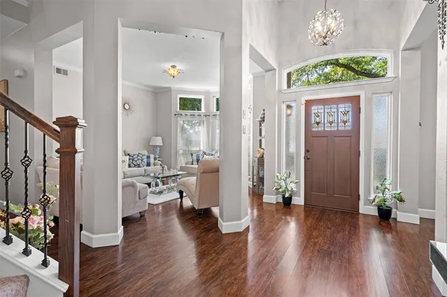 a view of an entryway with wooden floor and windows