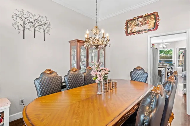 a dining room with furniture and wooden floor
