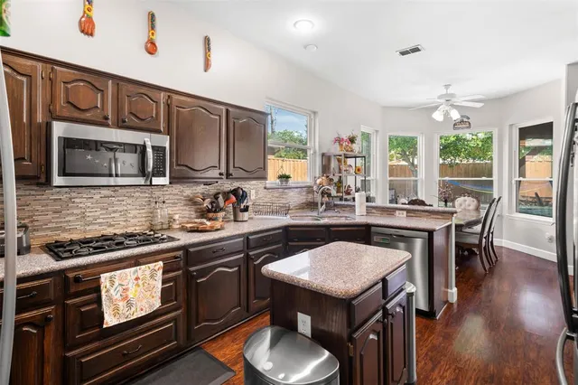 a kitchen with a stove a sink and a refrigerator