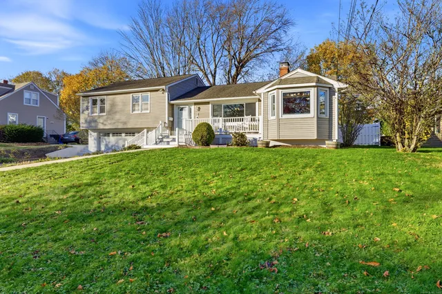 a front view of a house with a garden