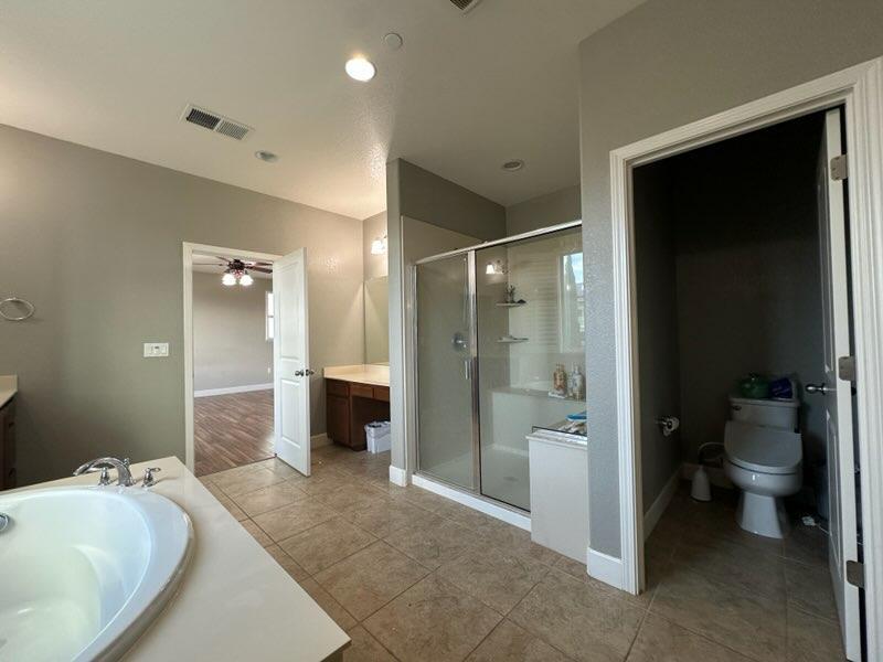 1749 Ettle Street Manteca, CA 95337 - Photo 8 of 12 a spacious bathroom with a bathtub sink and toilet