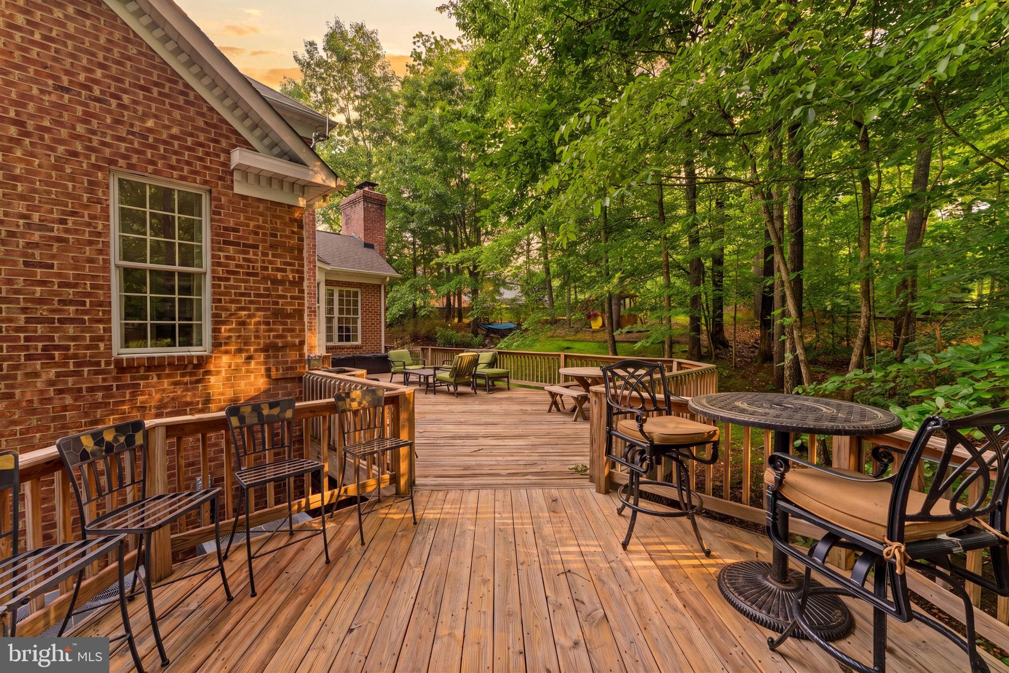 4531 Den Haag Road Warrenton, VA 20187 - Photo 87 of 103 a view of a patio with table and chairs and couches with wooden floor and fence