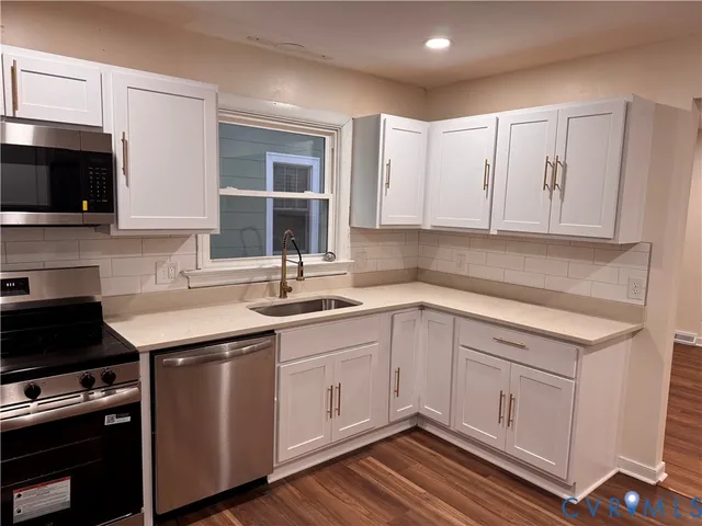 a kitchen with a sink stove and cabinets