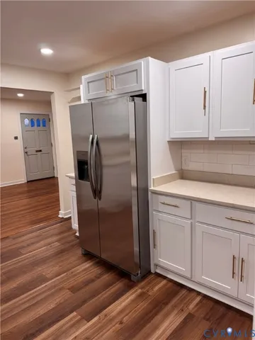 a kitchen with a refrigerator and cabinets