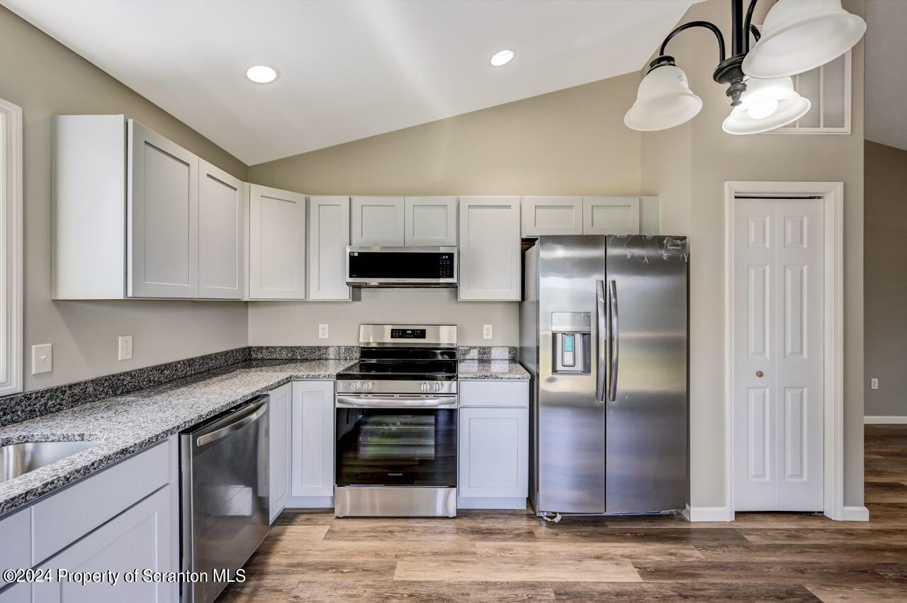 551 Back Street Scranton, PA 18504 - Photo 13 of 47 a kitchen with stainless steel appliances granite countertop a refrigerator a stove a sink and a microwave