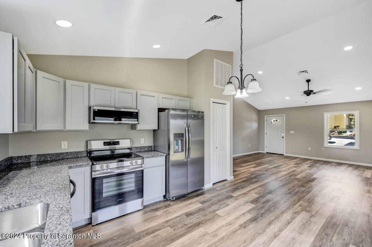 551 Back Street Scranton, PA 18504 - Photo 14 of 47 a kitchen with stainless steel appliances granite countertop a stove a refrigerator and a sink